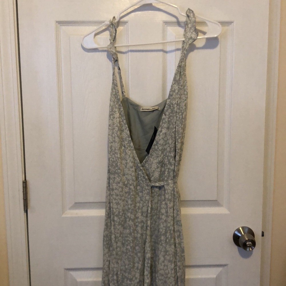 Never worn, new with tags. Light green floral high low wrap dress